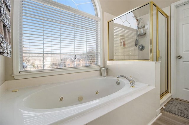 full bath with a wealth of natural light, a stall shower, and a jetted tub