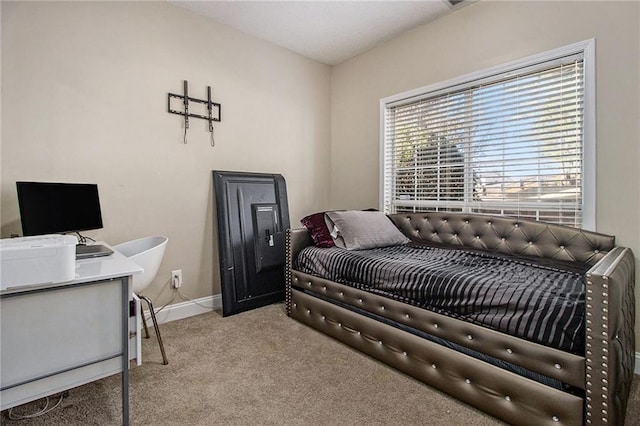 bedroom with baseboards and light colored carpet