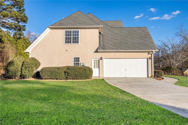 traditional-style home featuring concrete driveway, a garage, a front lawn, and stucco siding