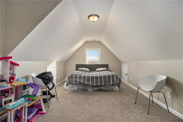 bedroom featuring baseboards, lofted ceiling, carpet, and a textured ceiling