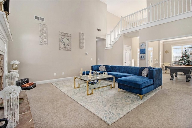 carpeted living room with visible vents, pool table, a stone fireplace, and baseboards