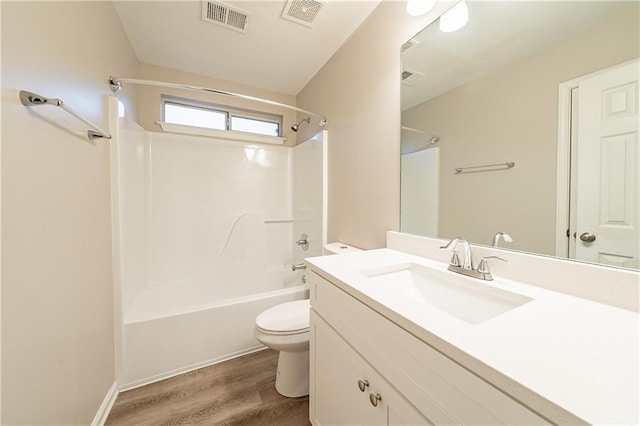 full bathroom with toilet, visible vents, tub / shower combination, and wood finished floors