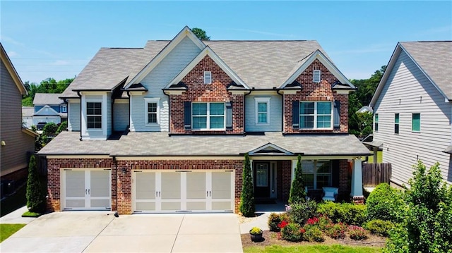 724 Laura Jean Ct, Buford, GA 30518 - craftsman-style house with brick siding, an attached garage, concrete driveway, and roof with shingles