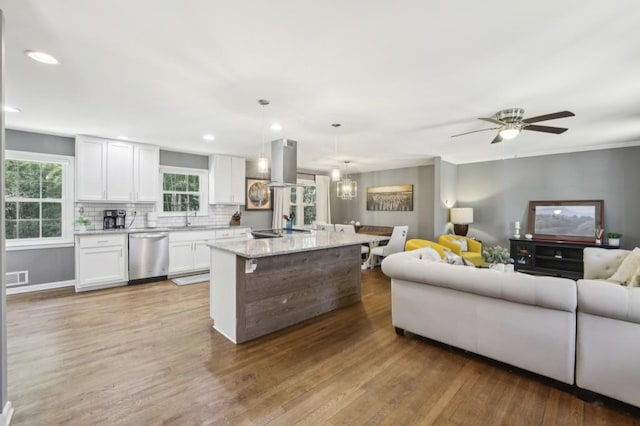 kitchen featuring light wood finished floors, island range hood, dishwasher, open floor plan, and white cabinetry