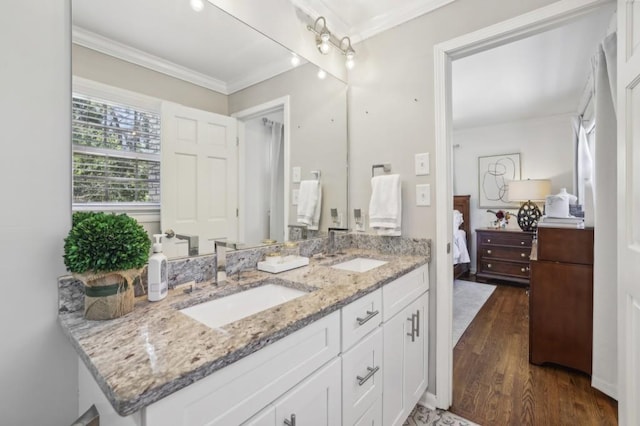 bathroom featuring crown molding, wood finished floors, a sink, and ensuite bathroom