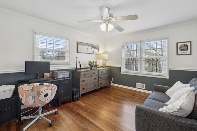 office space featuring a ceiling fan, visible vents, ornamental molding, and wood finished floors