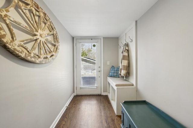 doorway to outside with dark wood finished floors and baseboards