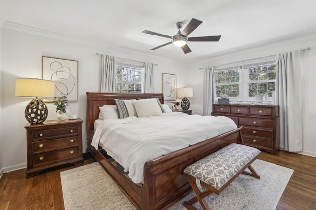 bedroom with dark wood-style floors, multiple windows, and crown molding