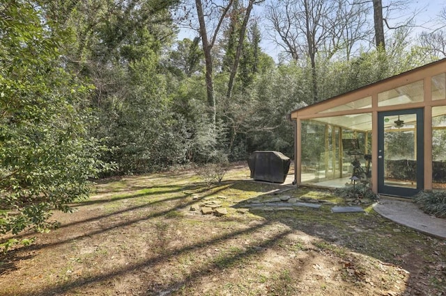 view of yard featuring a sunroom