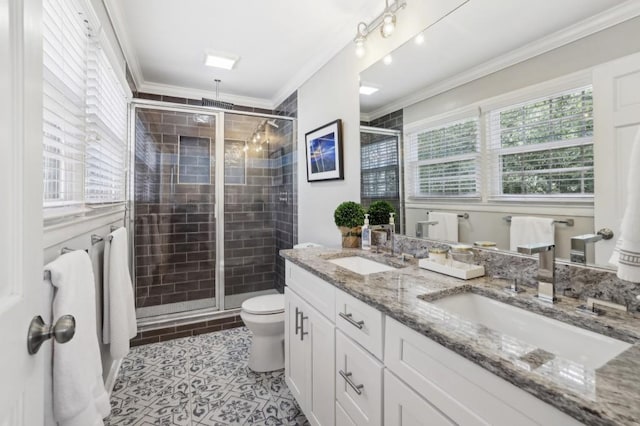 full bathroom with crown molding, a sink, a shower stall, and toilet