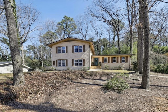 tri-level home featuring brick siding