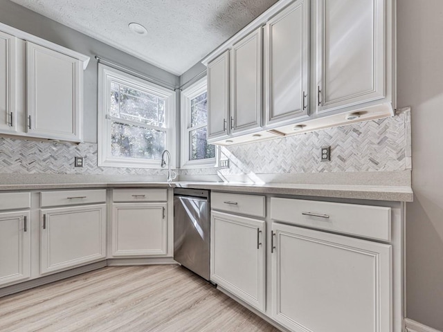 kitchen with white cabinets, a textured ceiling, light hardwood / wood-style floors, and stainless steel dishwasher