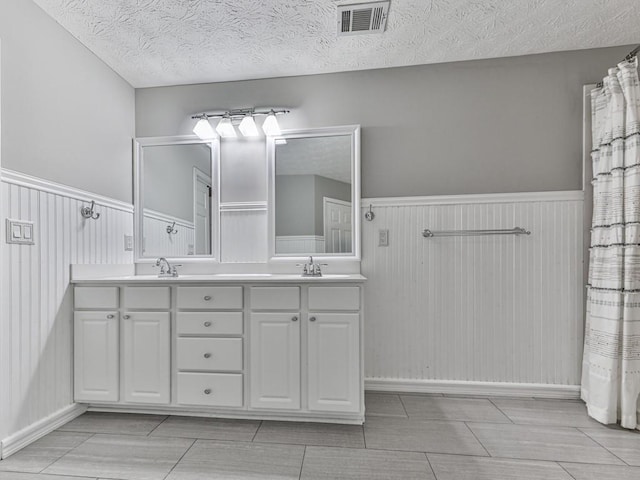 bathroom featuring vanity and a textured ceiling