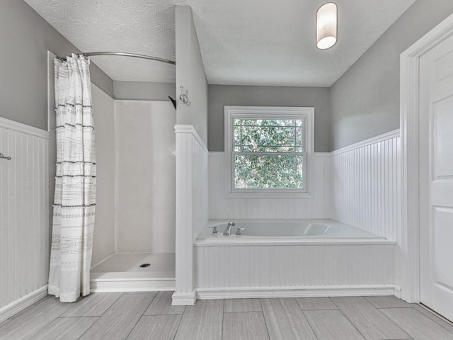 bathroom with shower with separate bathtub