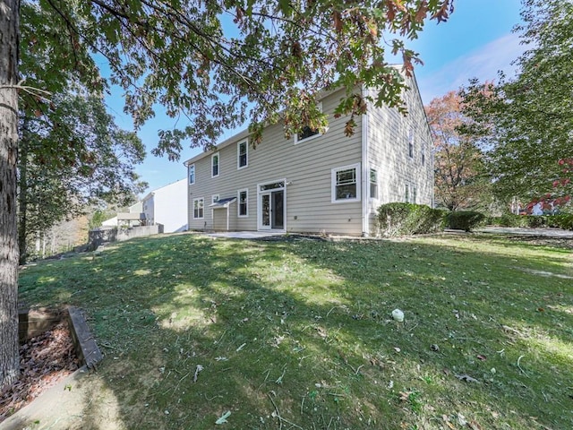 rear view of property featuring a yard and a patio