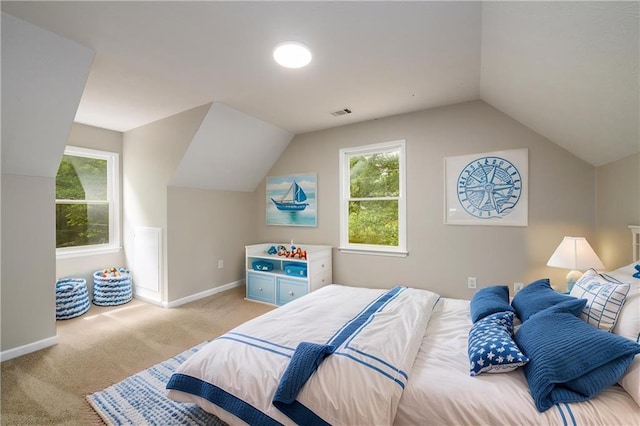 bedroom featuring lofted ceiling, light colored carpet, multiple windows, and baseboards