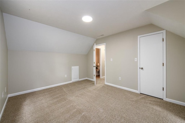 bonus room with lofted ceiling, carpet, and baseboards