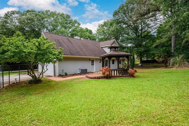 rear view of property with a gazebo, central AC, a garage, driveway, and a shingled roof