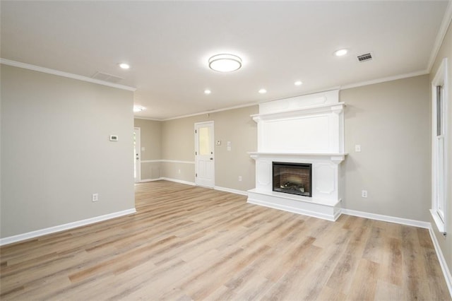 unfurnished living room with ornamental molding, recessed lighting, a large fireplace, light wood finished floors, and baseboards