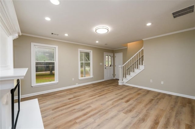 foyer entrance featuring ornamental molding, light wood finished floors, recessed lighting, stairs, and baseboards