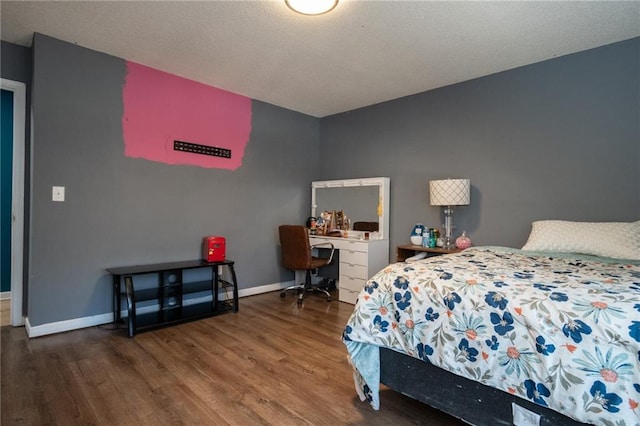 bedroom with wood finished floors and baseboards