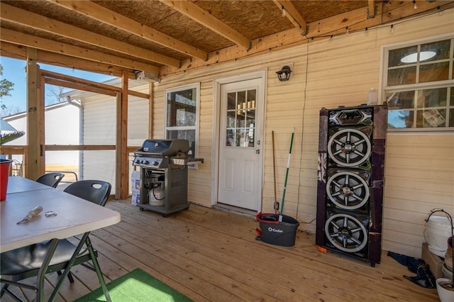 wooden deck featuring a grill