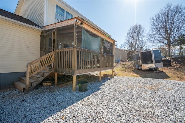 rear view of house featuring a wooden deck