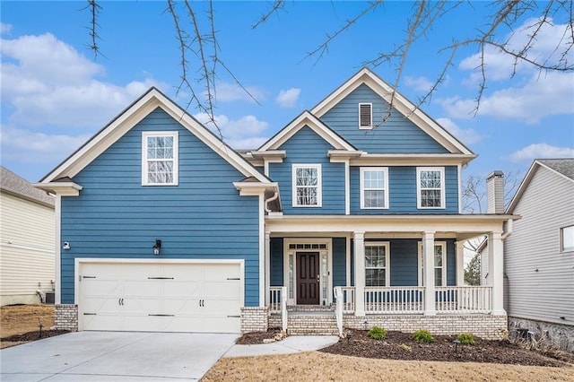 craftsman-style house featuring cooling unit, a garage, and covered porch