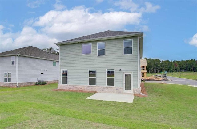 rear view of property featuring a patio area and a yard