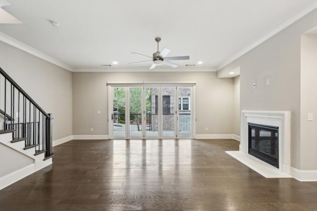 unfurnished living room featuring ornamental molding, baseboards, ceiling fan, and wood finished floors