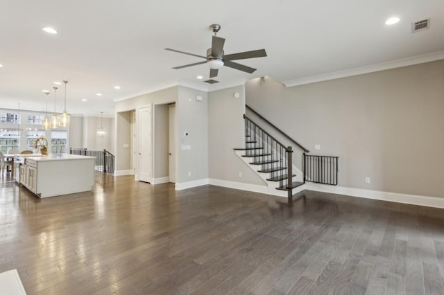 unfurnished living room with dark wood-style flooring, ornamental molding, and a ceiling fan