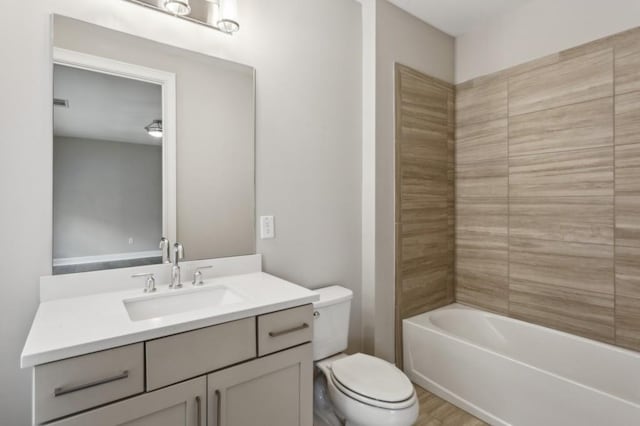 bathroom with visible vents, toilet, vanity, and shower / bathtub combination