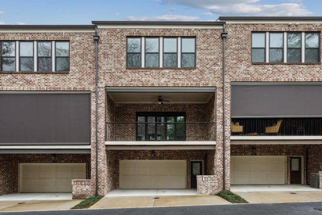 view of property with central AC unit, driveway, an attached garage, and brick siding
