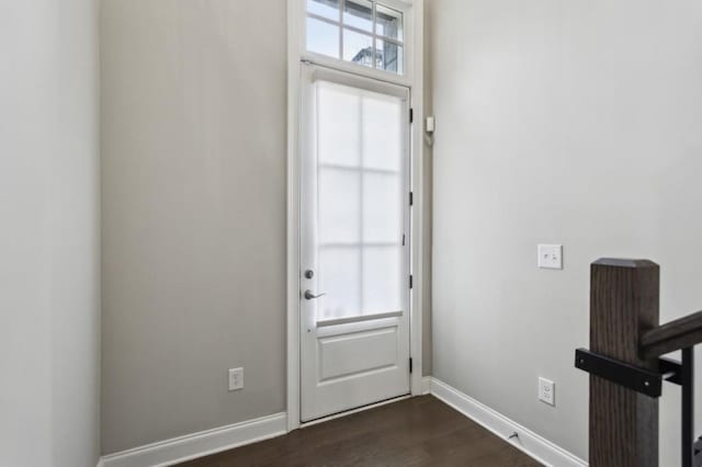 doorway with plenty of natural light, baseboards, and dark wood finished floors