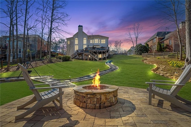 exterior space with a yard, a patio area, fence, and an outdoor fire pit