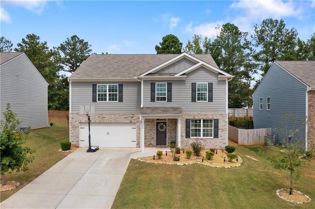 craftsman inspired home featuring central AC, a garage, and a front lawn