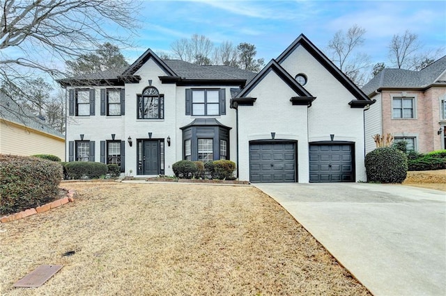 view of front of property featuring brick siding, an attached garage, and concrete driveway