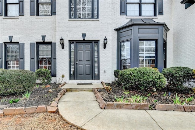 property entrance featuring brick siding