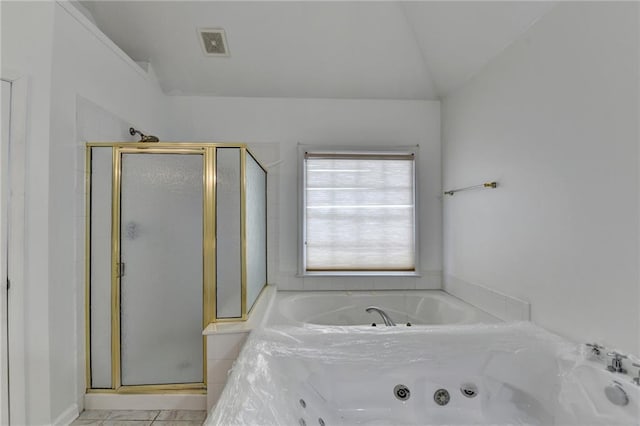 bathroom featuring lofted ceiling, a tub with jets, visible vents, and a stall shower