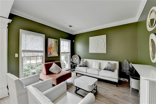 living room featuring visible vents, crown molding, and wood finished floors