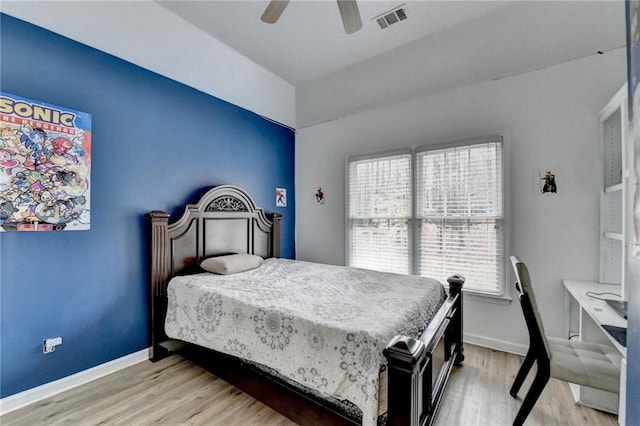 bedroom featuring light wood-type flooring, visible vents, and baseboards