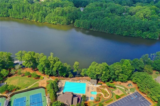 birds eye view of property featuring a wooded view and a water view