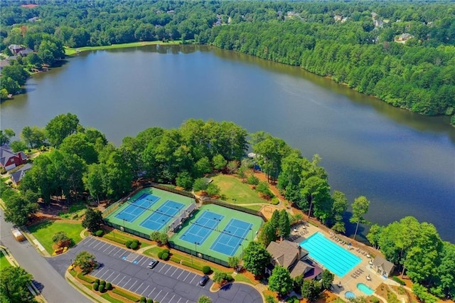 drone / aerial view with a view of trees and a water view