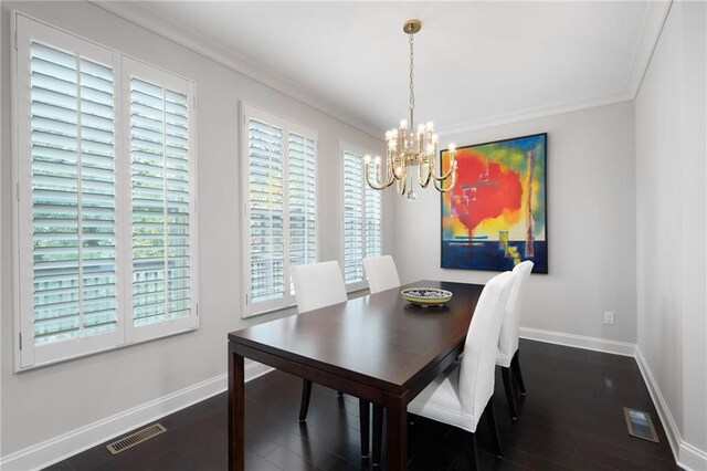 dining area with dark hardwood / wood-style flooring, an inviting chandelier, and crown molding