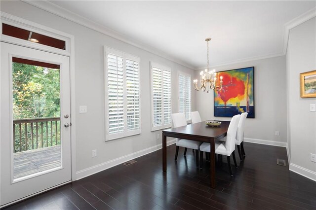 dining room featuring crown molding, dark hardwood / wood-style flooring, and a notable chandelier