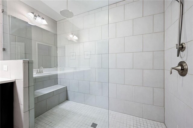 bathroom with vanity, tile patterned floors, and tiled shower