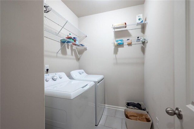 laundry room with separate washer and dryer and tile patterned flooring