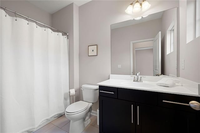 bathroom featuring vanity, tile patterned flooring, and toilet