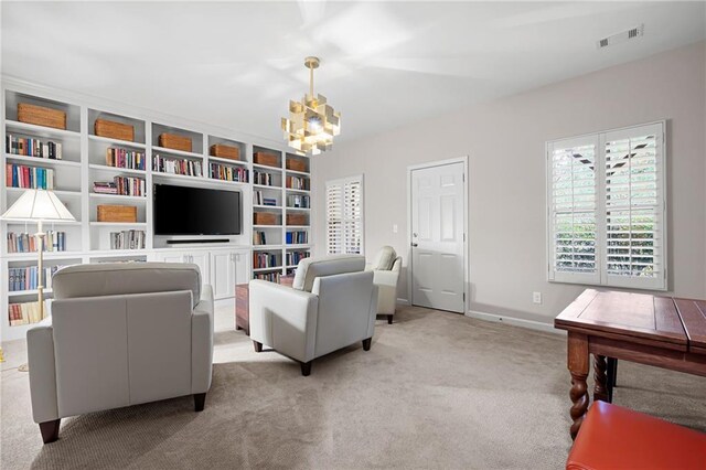 living room featuring light colored carpet and an inviting chandelier