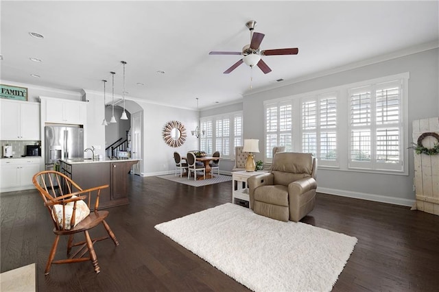 244 Rope Mill Rd, Woodstock, GA 30188 - living area featuring ceiling fan, baseboards, arched walkways, ornamental molding, and dark wood-style flooring